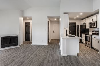 A modern kitchen with a white island and stainless steel appliances